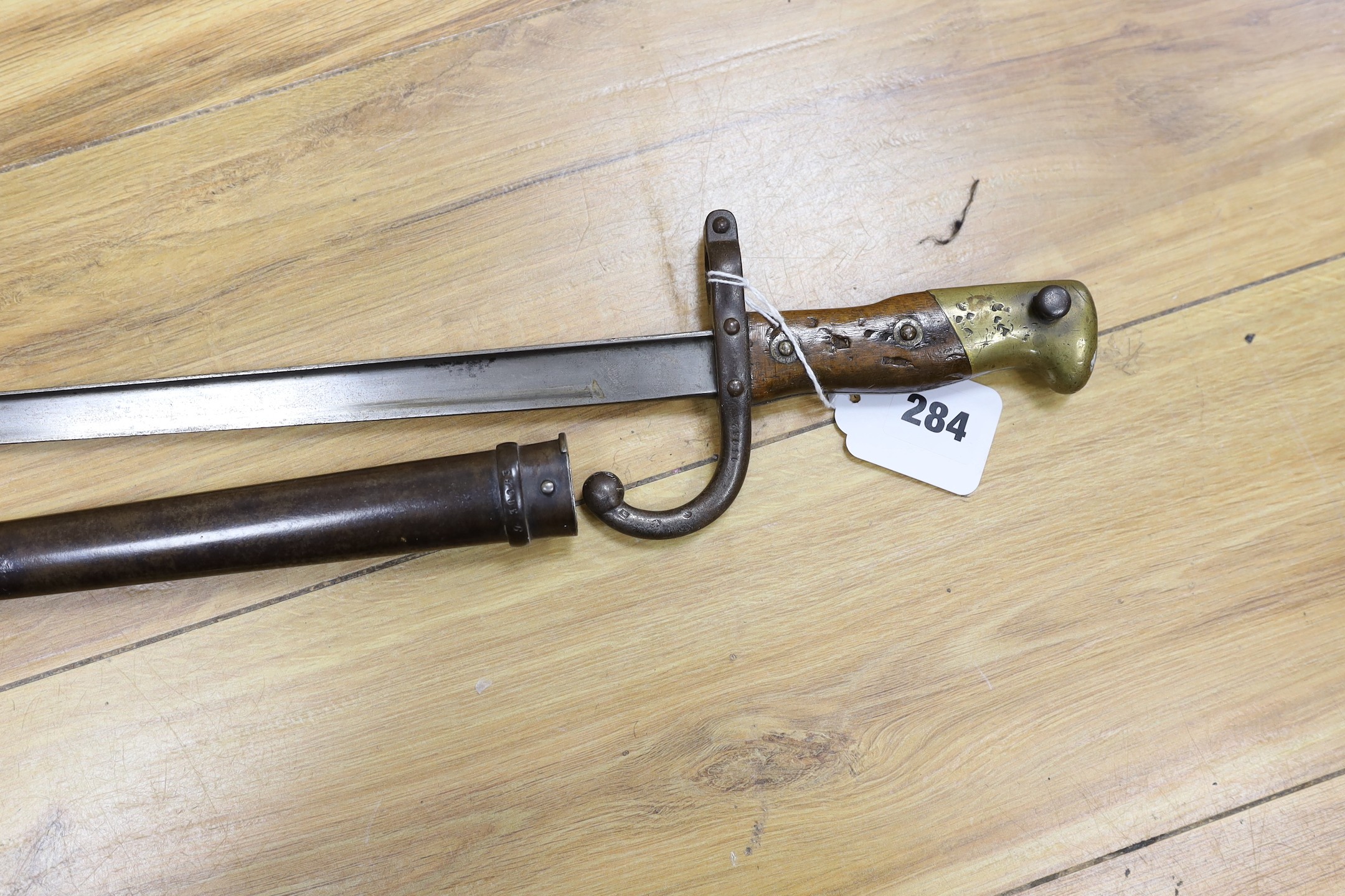 A Victorian officer's sword, lacking sheath, together with a 19th century French ’1877’ bayonet and sheath